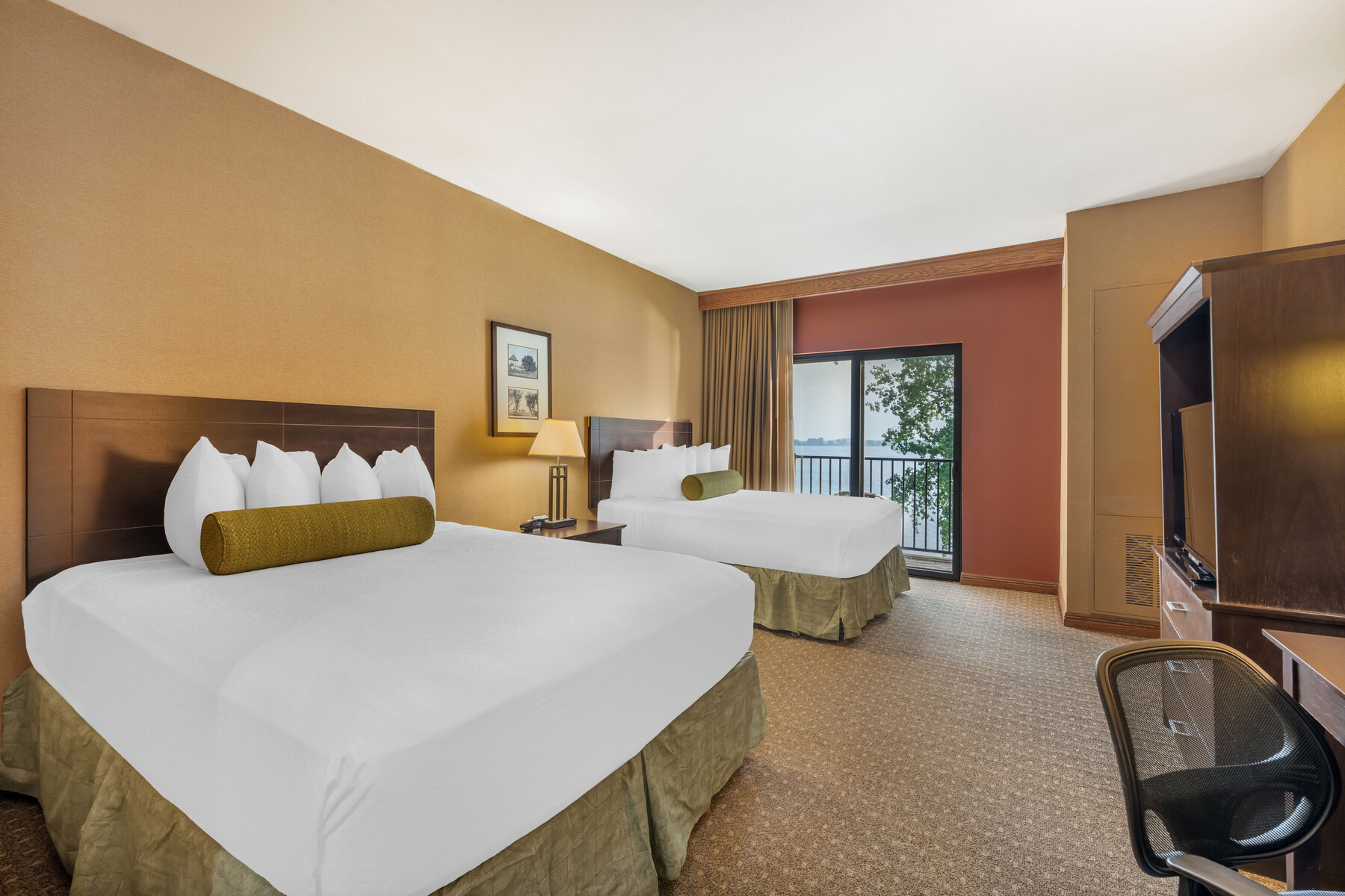 a room with two beds and a balcony