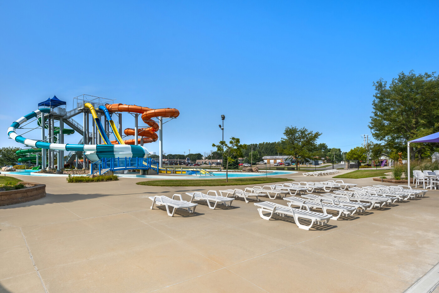 a water park with a slide and chairs